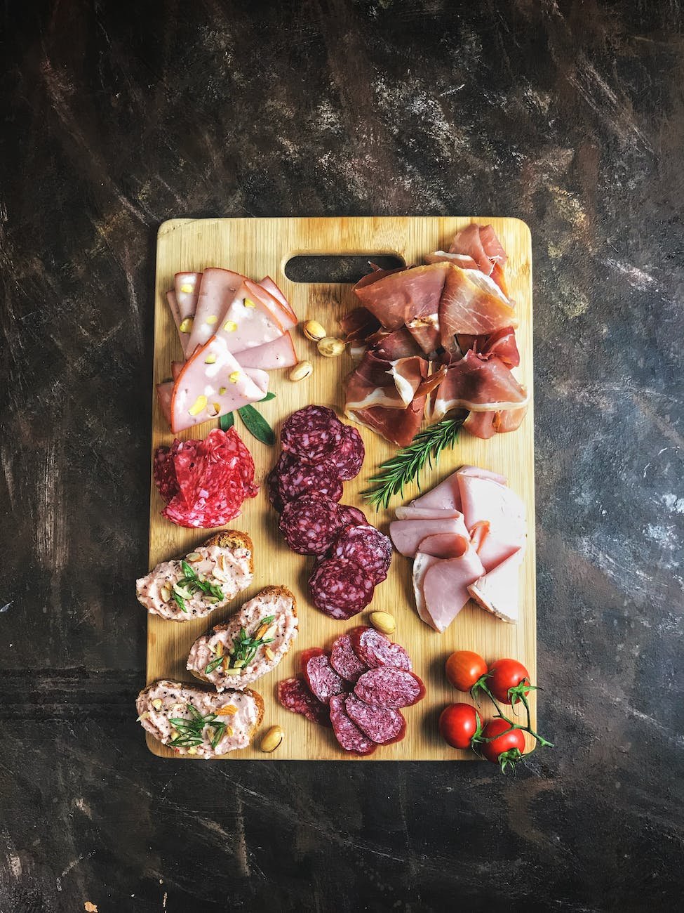 sliced meats on wooden chopping board